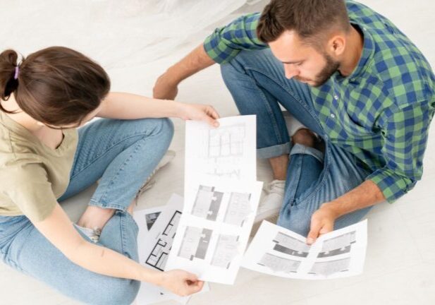 Homeowners reviewing house plans together to reduce renovation stress before building